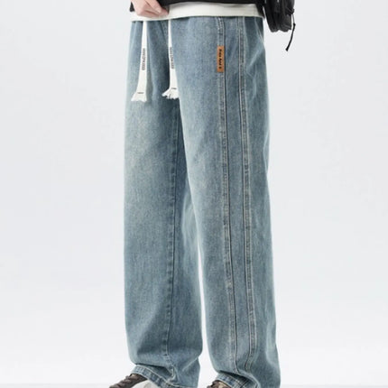 Men's full size washed loose fit wide leg jeans with drawstring and slight stretch in 100% cotton