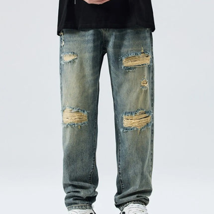 Men's distressed wide leg jeans in washed denim with ripped details and relaxed fit