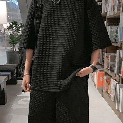 Men's textured black oversized short sleeve t-shirt and shorts set with slight stretch, made of 100% polyester.