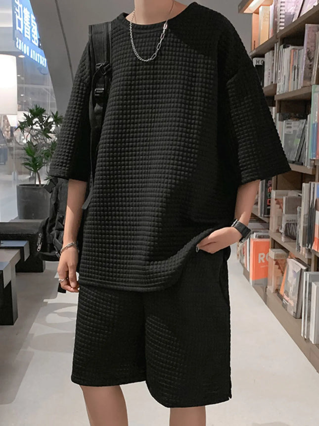 Men's textured black oversized short sleeve t-shirt and shorts set with slight stretch, made of 100% polyester.