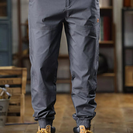 Men's full size wide leg pants in gray with drawstring waist and pockets, styled with tan boots.