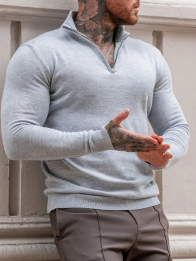 Men's plus size quarter zip long sleeve stretchy sweater in light gray with a basic style, worn by a tattooed man.